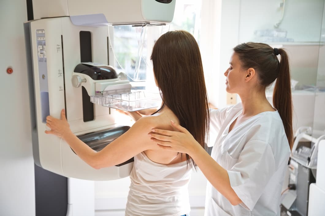 A woman receives a mammogram